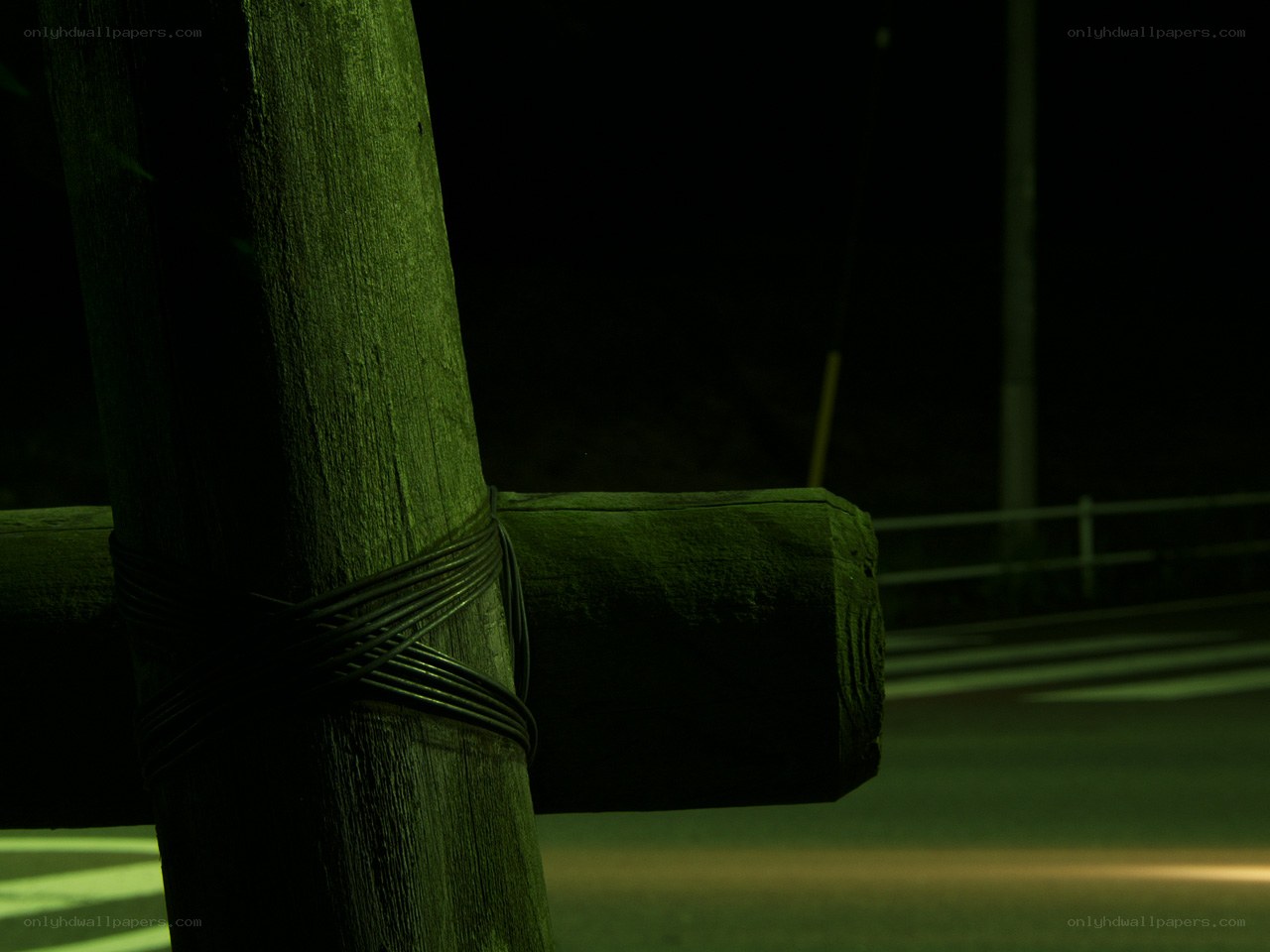 Nighttime wooden post with wires