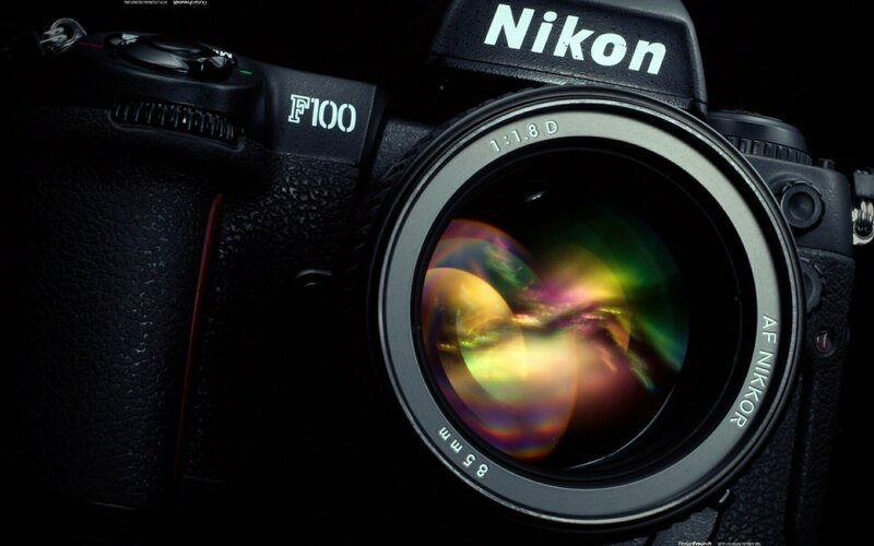 Nikon F100 camera with lens