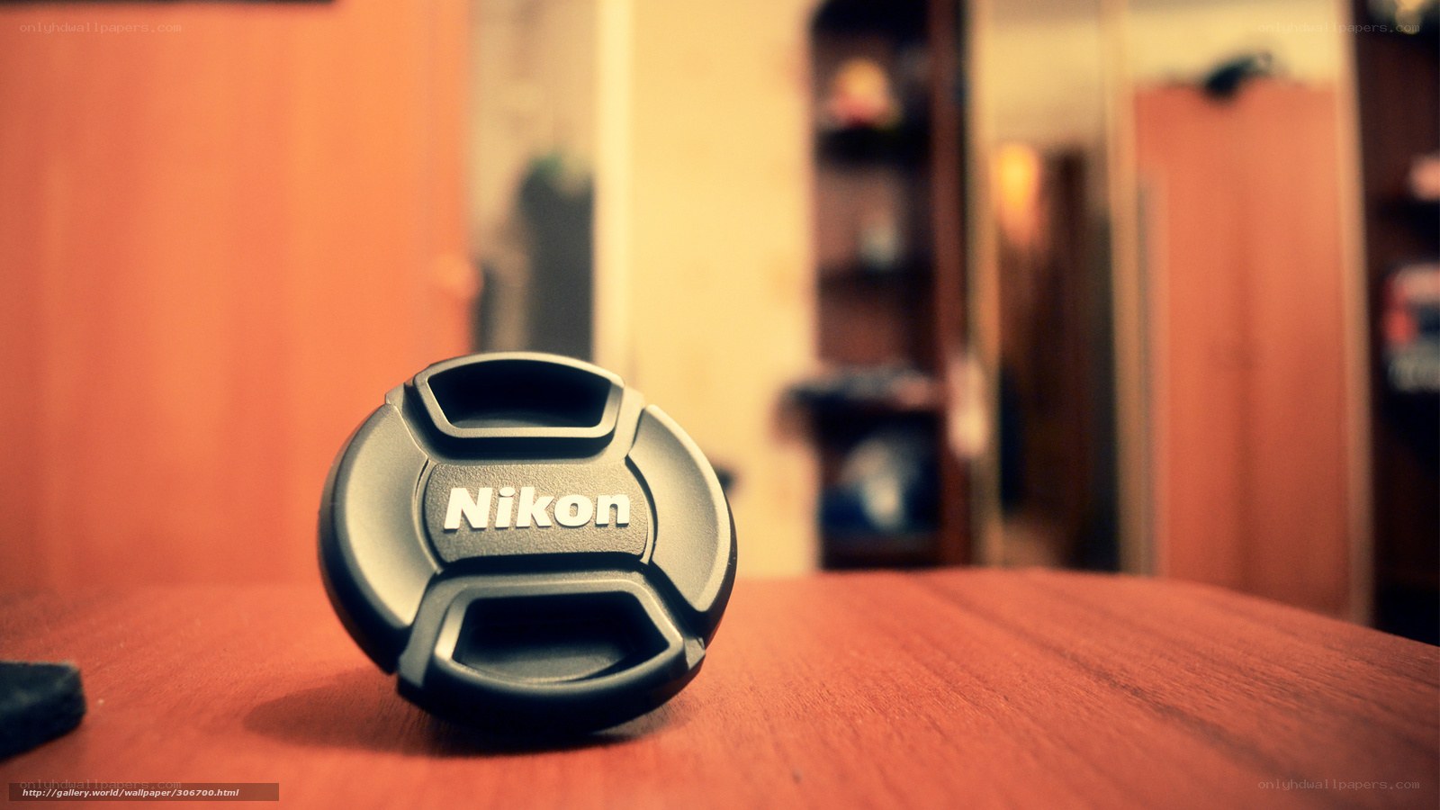 Nikon lens cap on wooden table