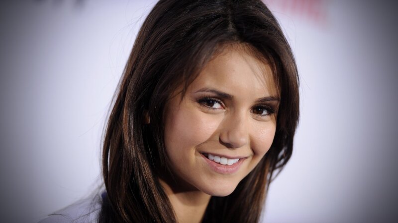 Nina Dobrev smiling at event