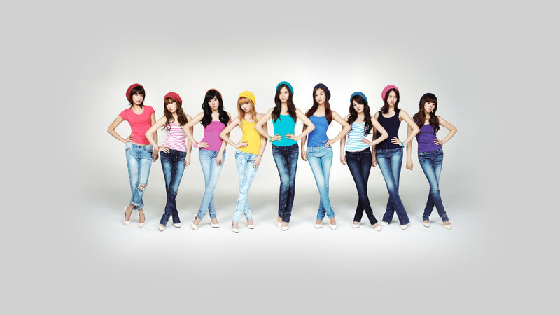 nine women in colorful tops