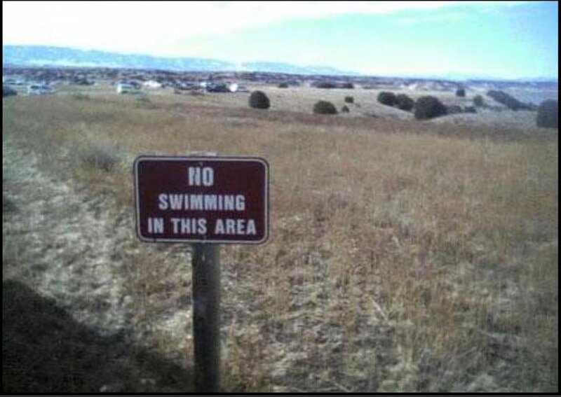 No swimming sign in dry field