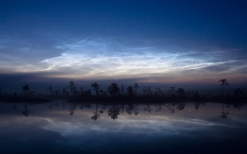 Noctilucent clouds over a lake