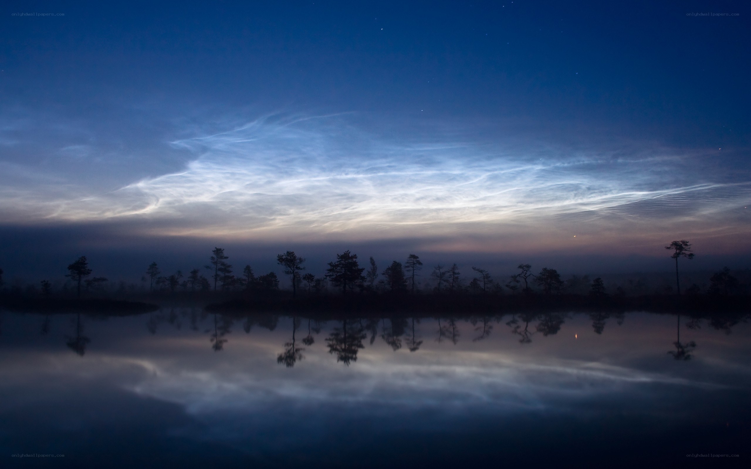 Noctilucent clouds over a lake