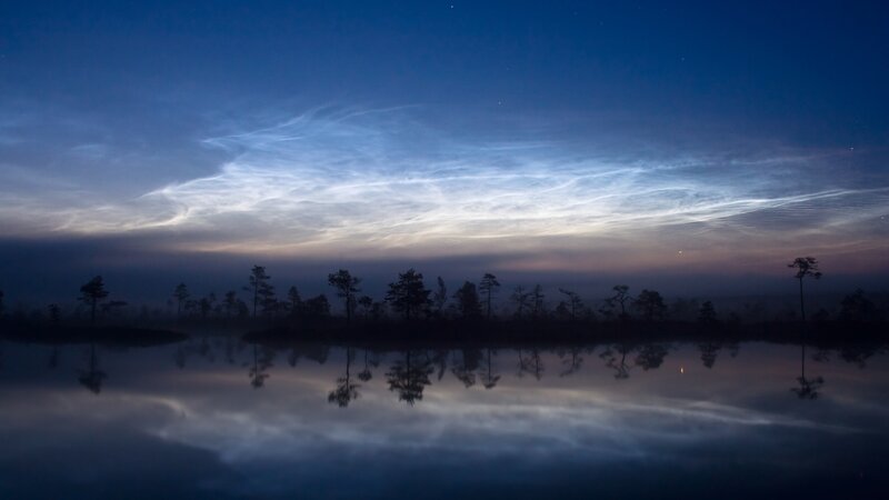 Noctilucent clouds over a lake