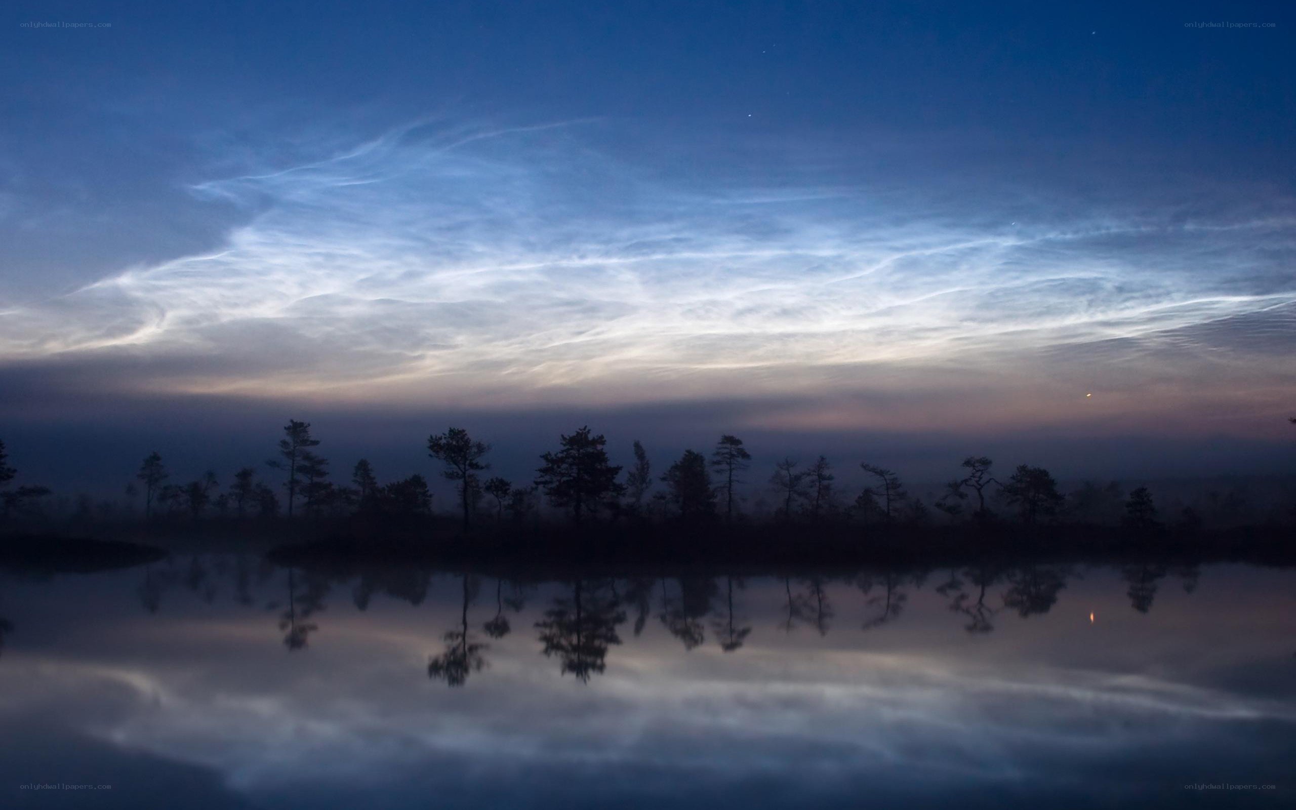 Noctilucent clouds over a lake