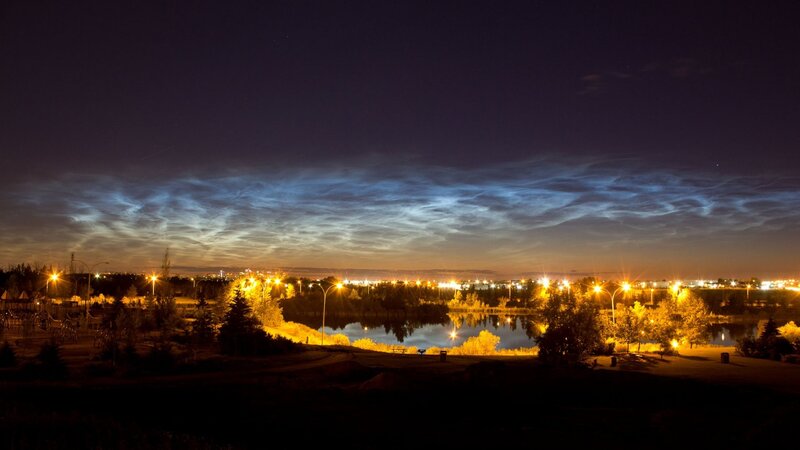 Noctilucent clouds over a park