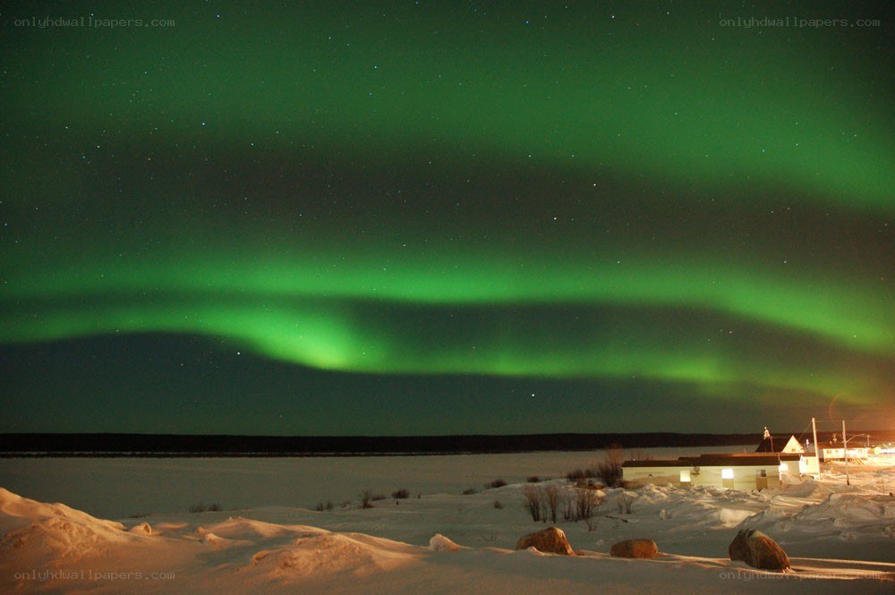 Northern Lights over snowy landscape