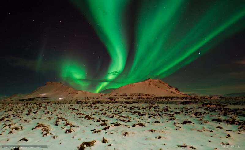 Northern Lights over snowy mountains