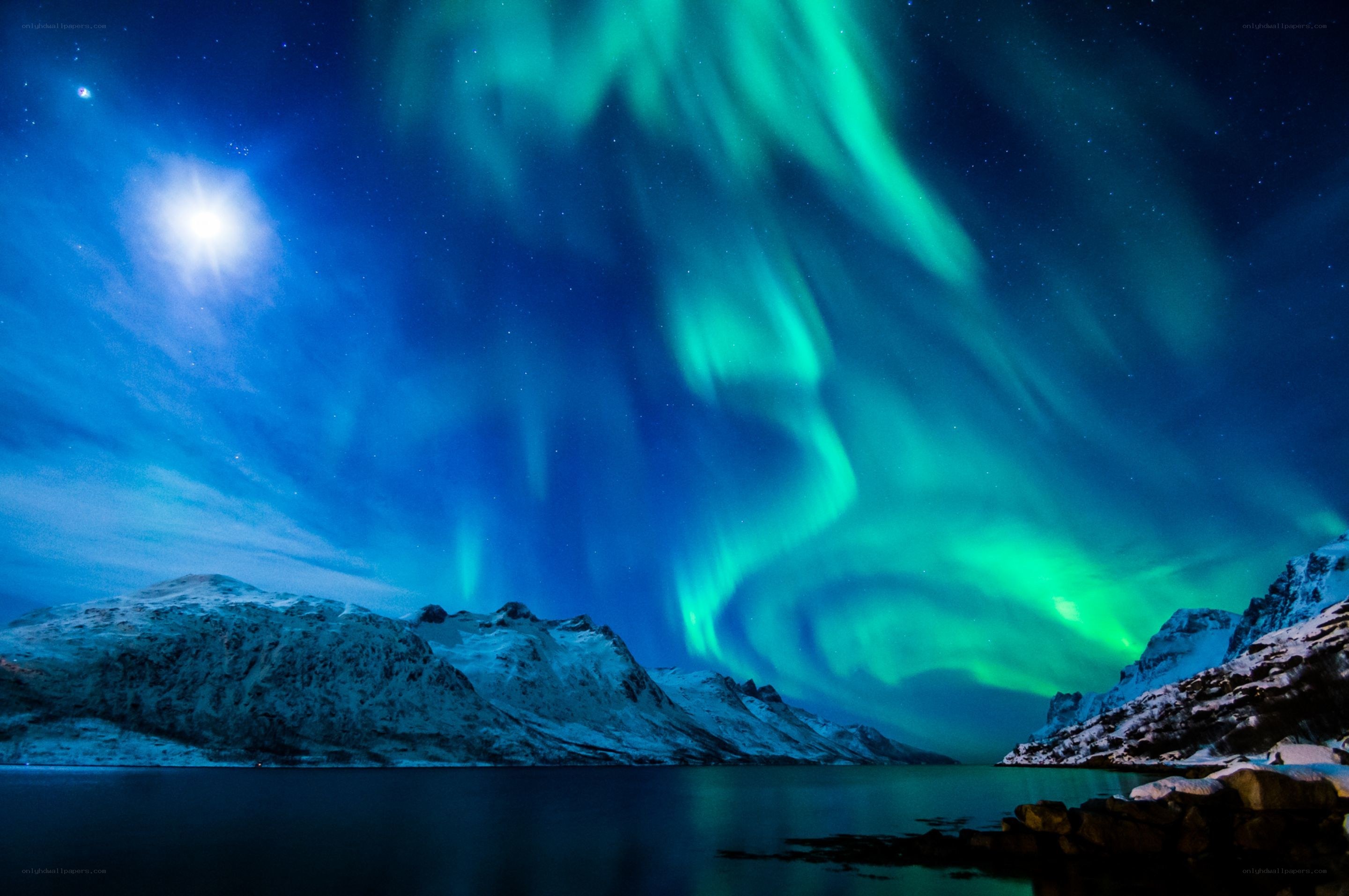 Northern Lights over snowy mountains