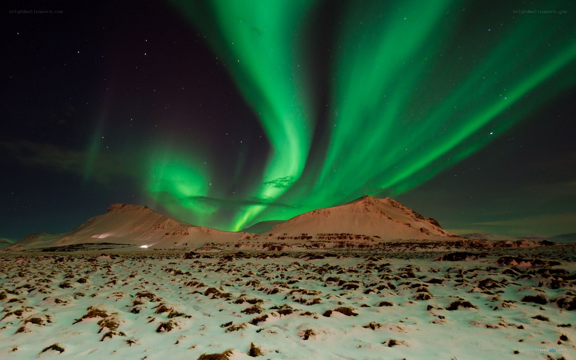 Northern Lights over snowy mountains