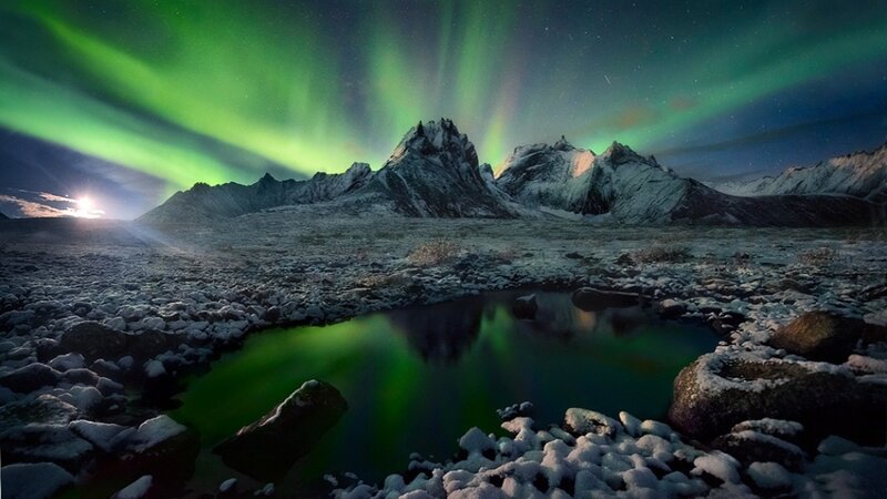 Northern Lights over snowy mountains