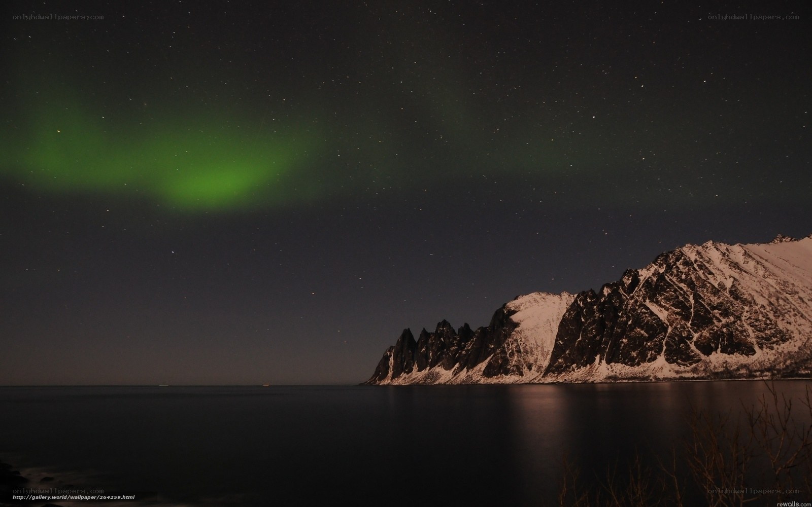 Northern Lights over snowy mountains