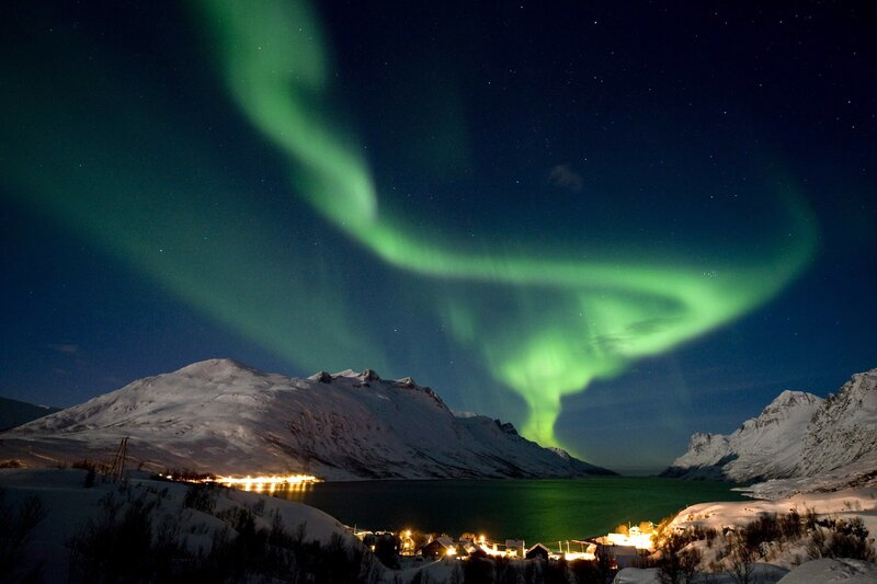 Northern Lights over snowy village