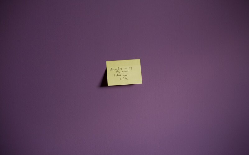 note on purple wall