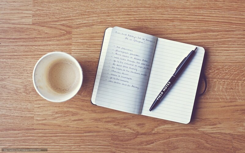 notebook and coffee on table