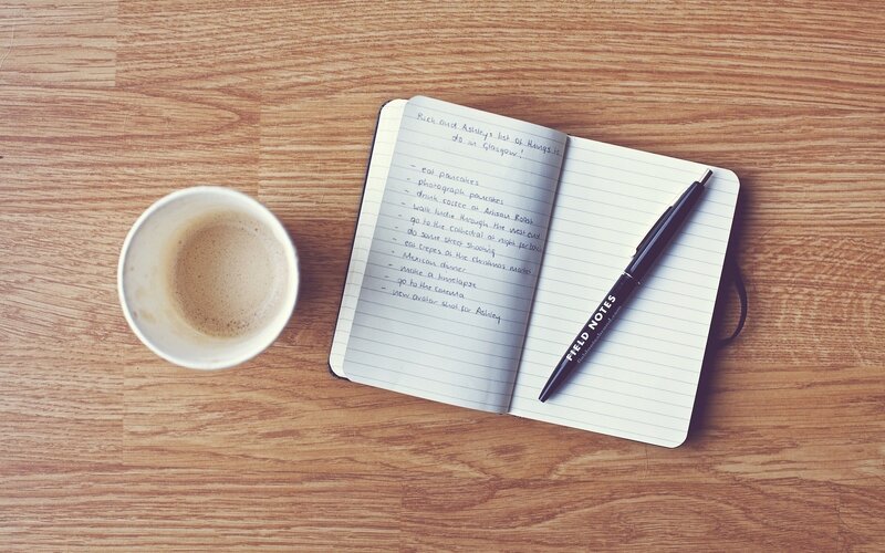 notebook and coffee on wood