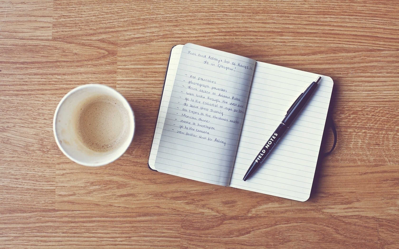 notebook and coffee on wood