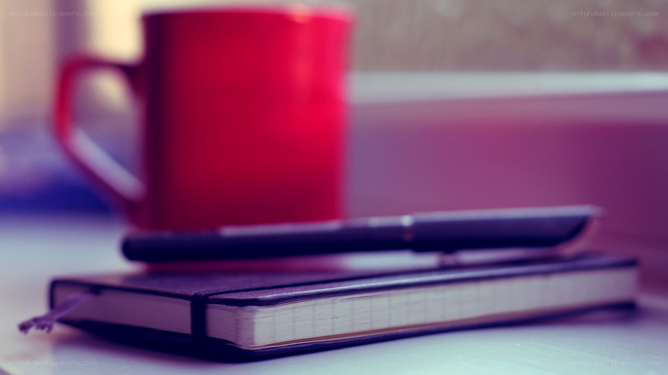 notebook and mug on table