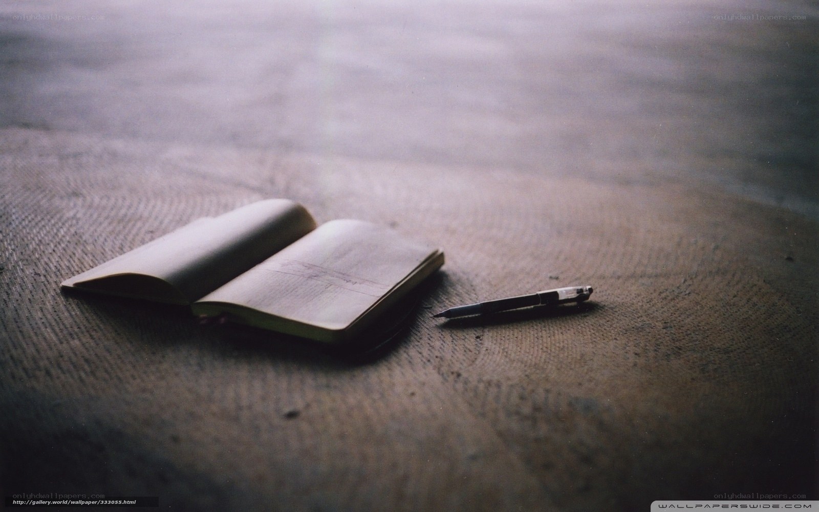 notebook and pen on floor