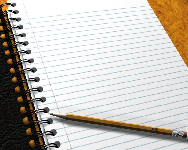 notebook and pencil on desk
