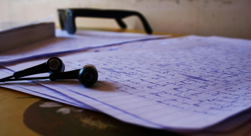 notebook with earbuds on desk