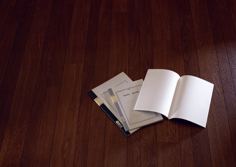 notebooks on wooden floor