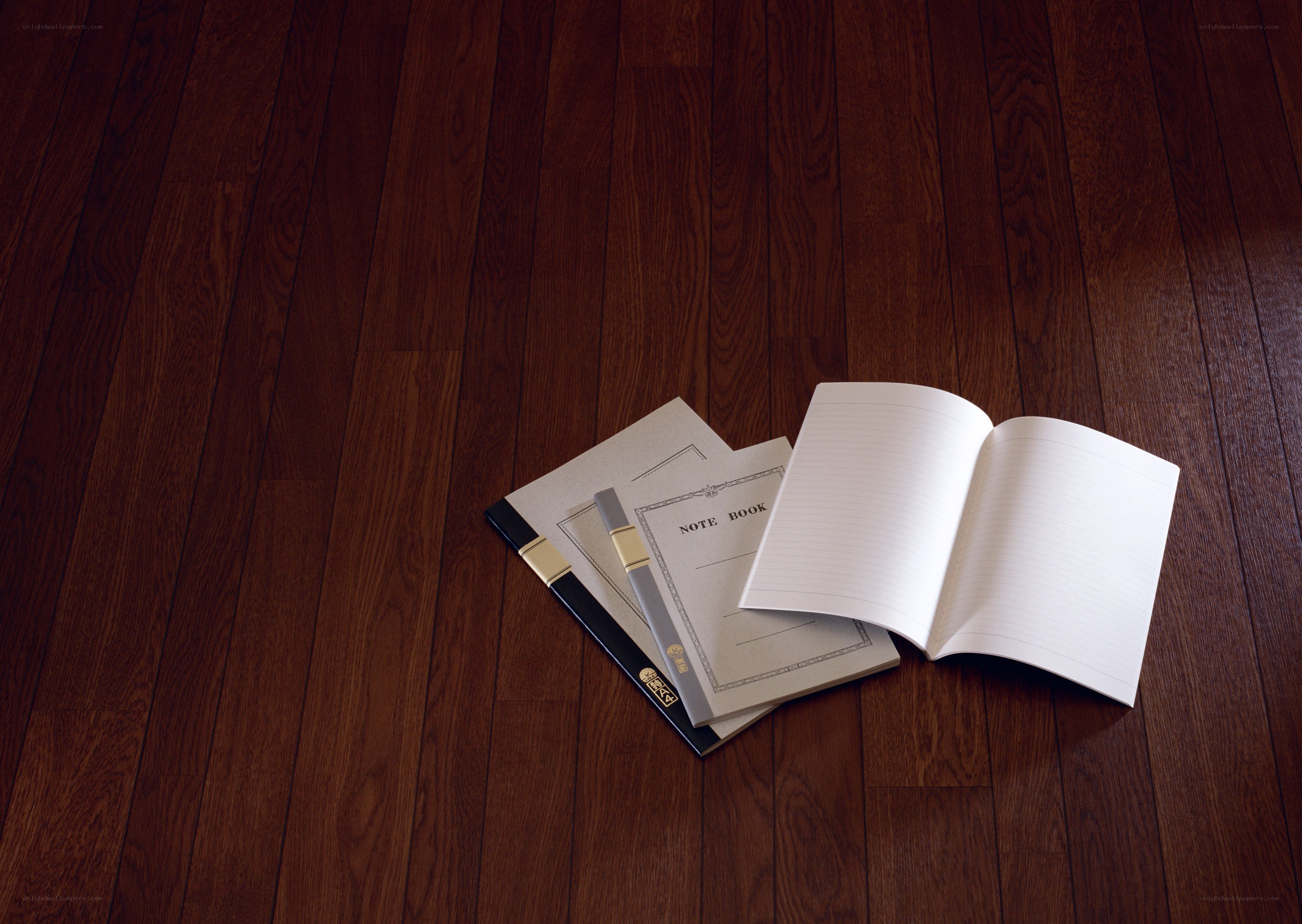 notebooks on wooden floor