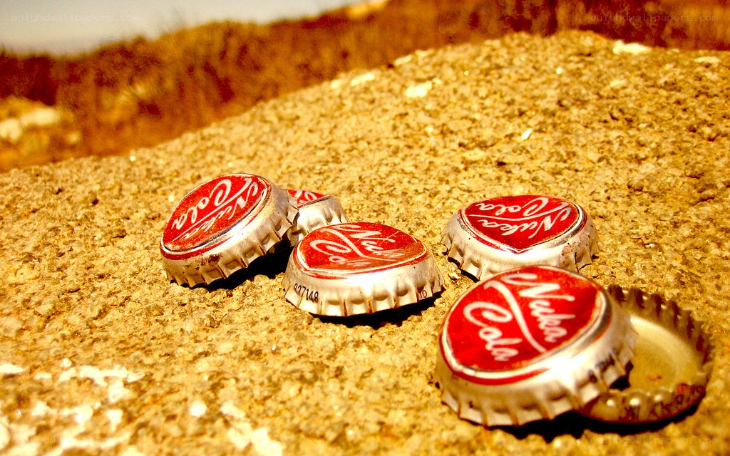 Nuka-Cola bottle caps on sand
