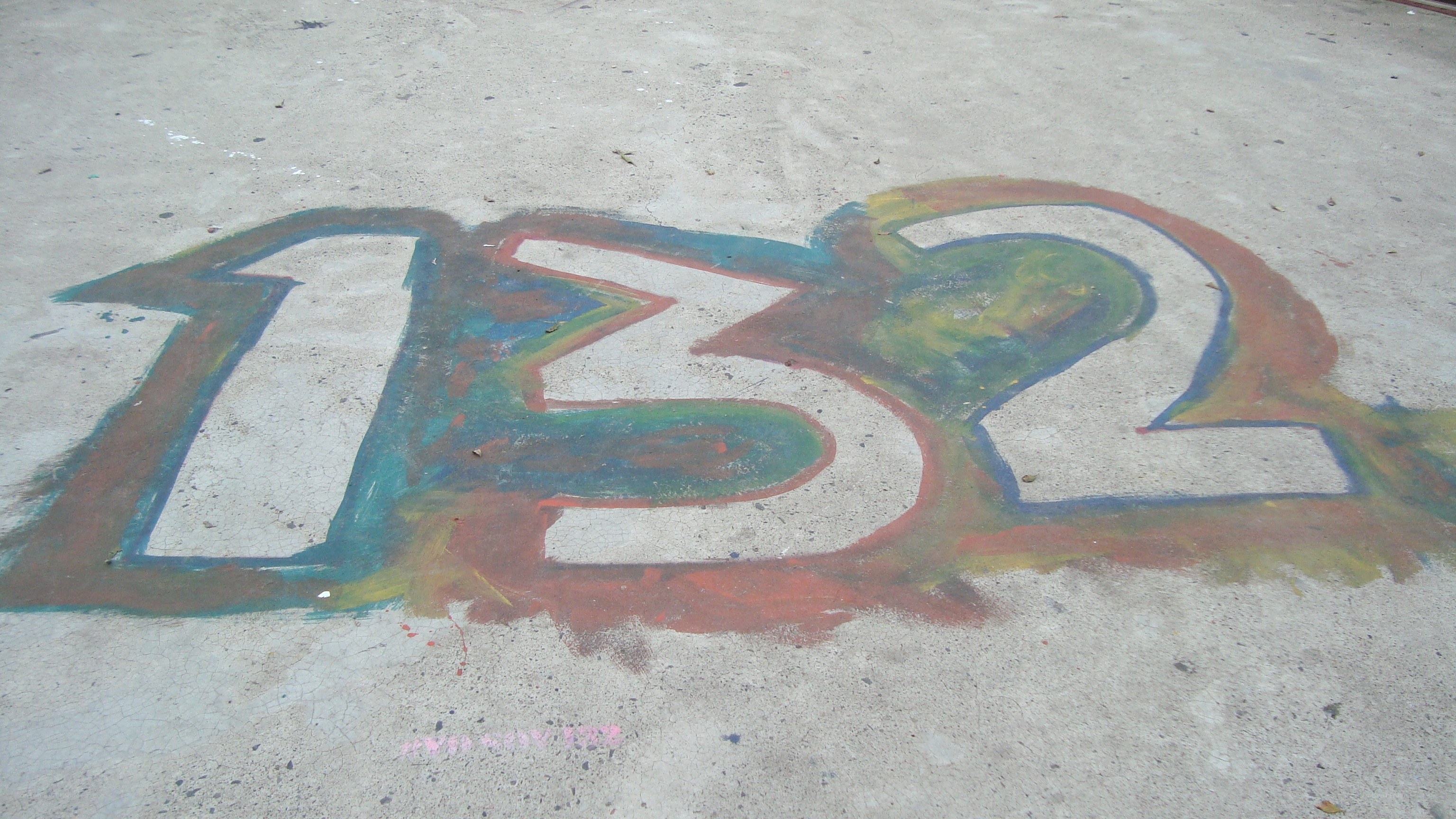 number 132 drawn on pavement