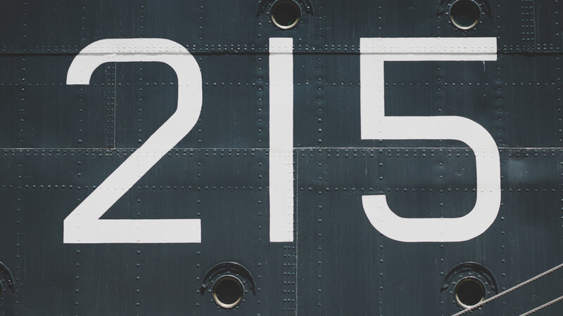 Number 215 on Metal Surface