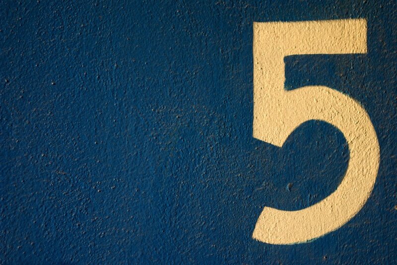 number five on blue wall