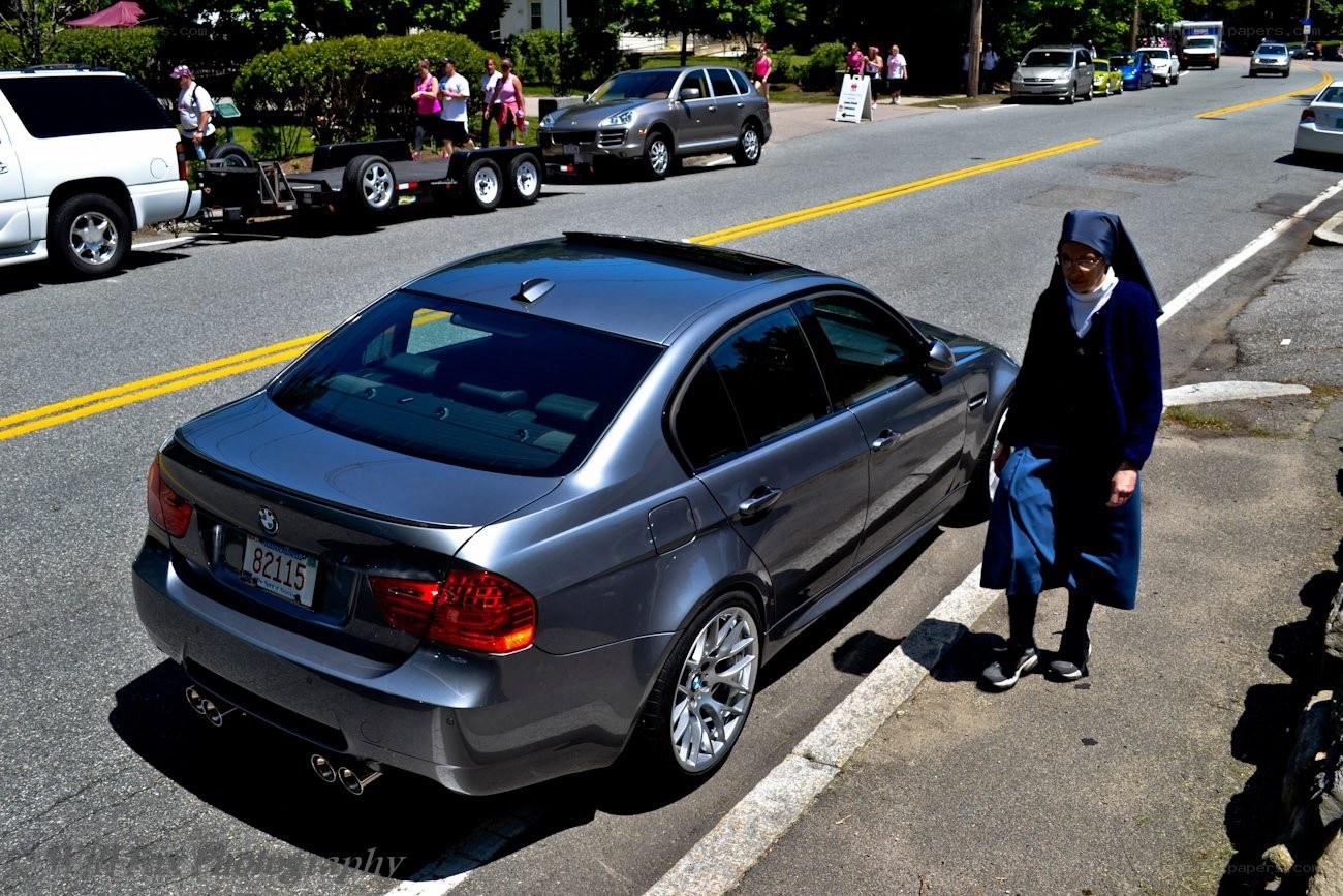 Nun walking near a car