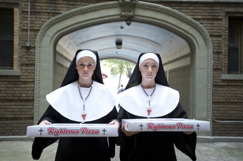 Nuns holding pizza boxes