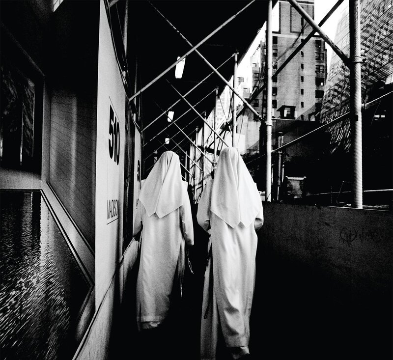 Nuns walking on a city sidewalk