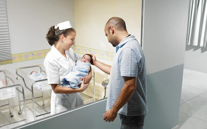 Nurse holding newborn baby