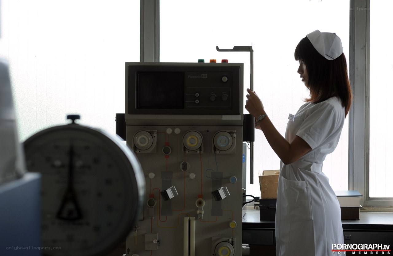 Nurse operating medical equipment