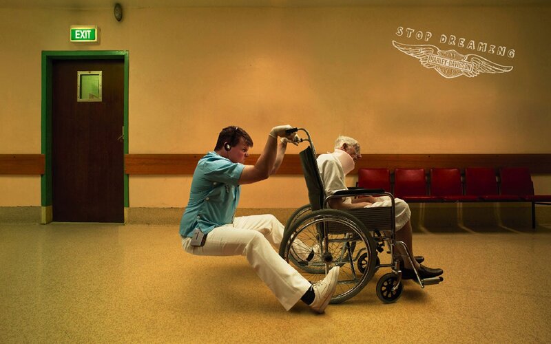 Nurse pushing wheelchair in hospital