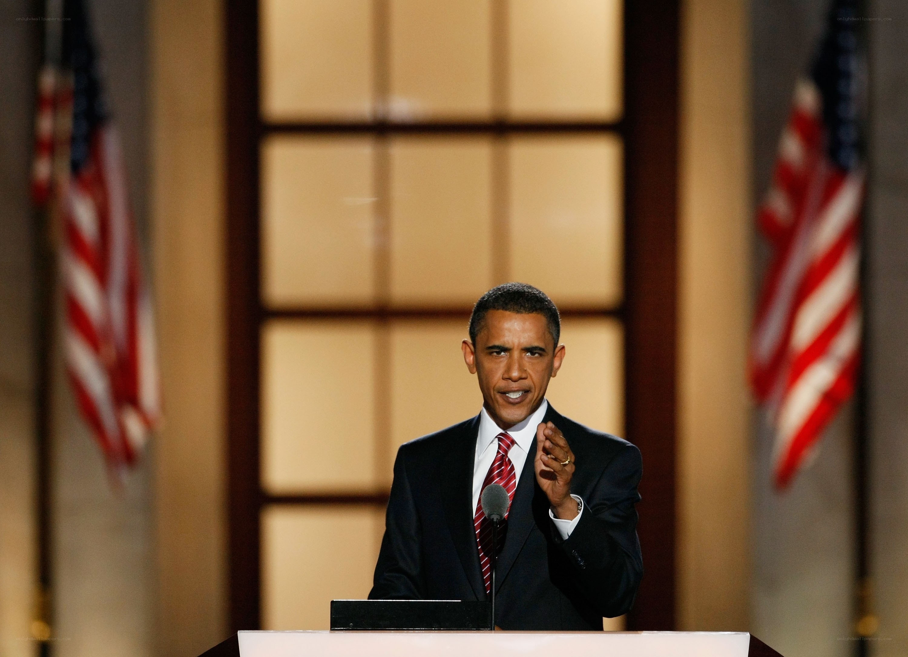 Obama at podium with flags
