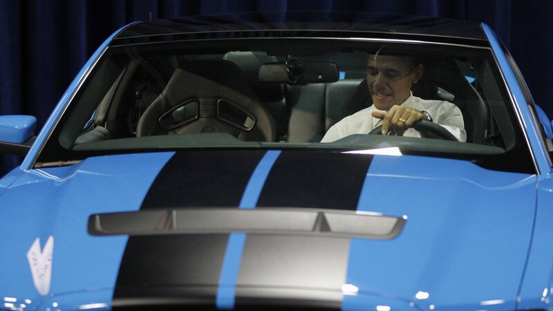 Obama in a blue sports car