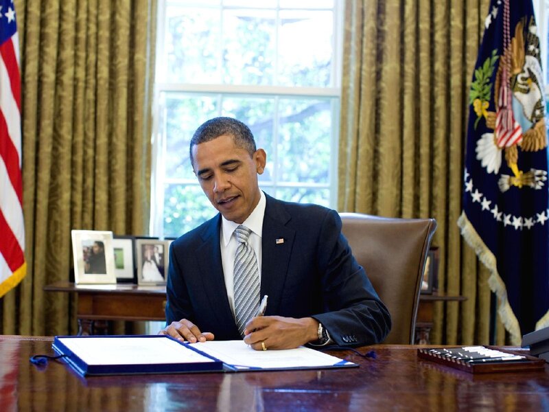 Obama signing a document