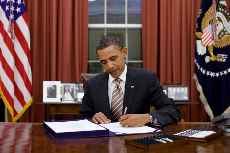Obama signing a document