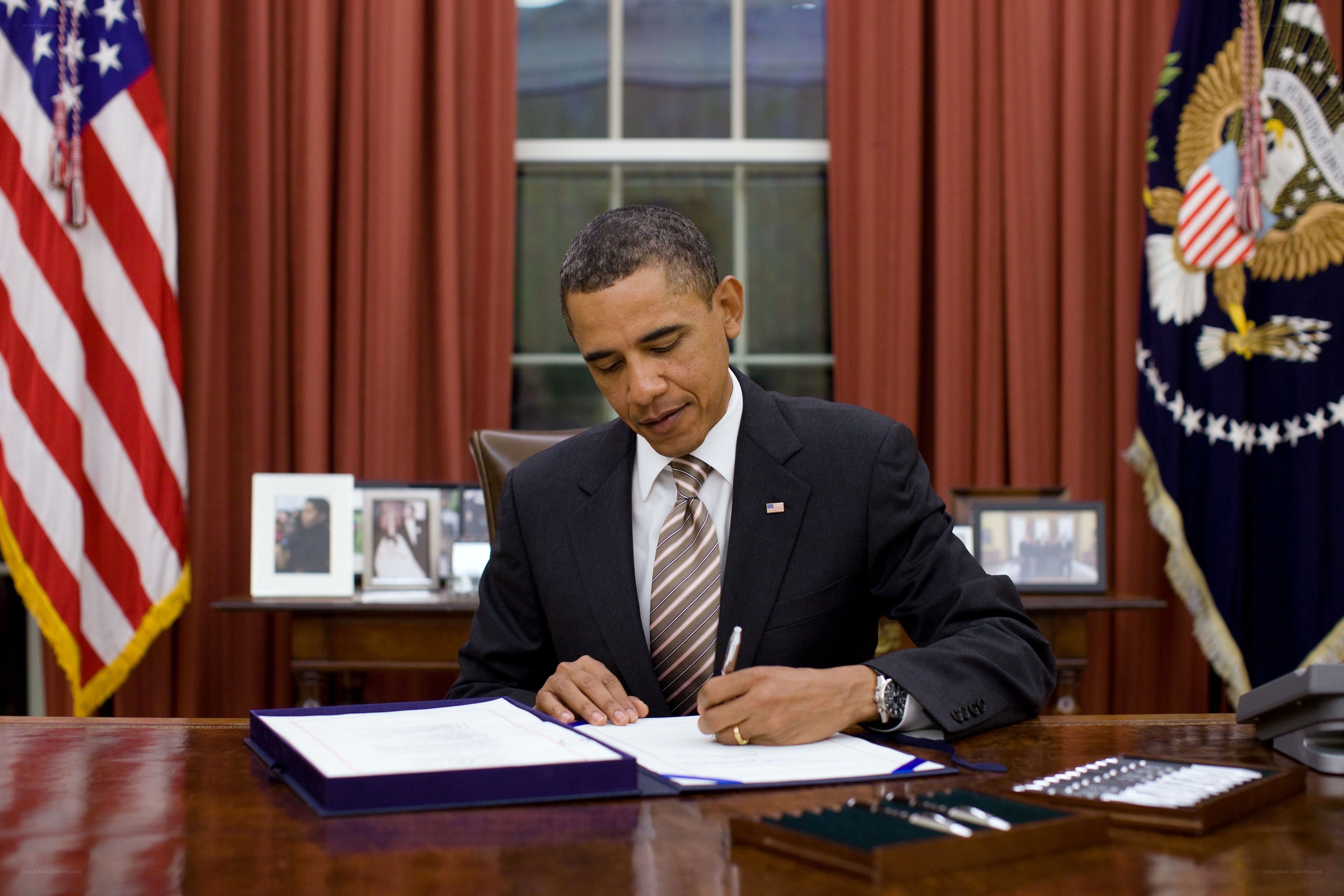 Obama signing a document