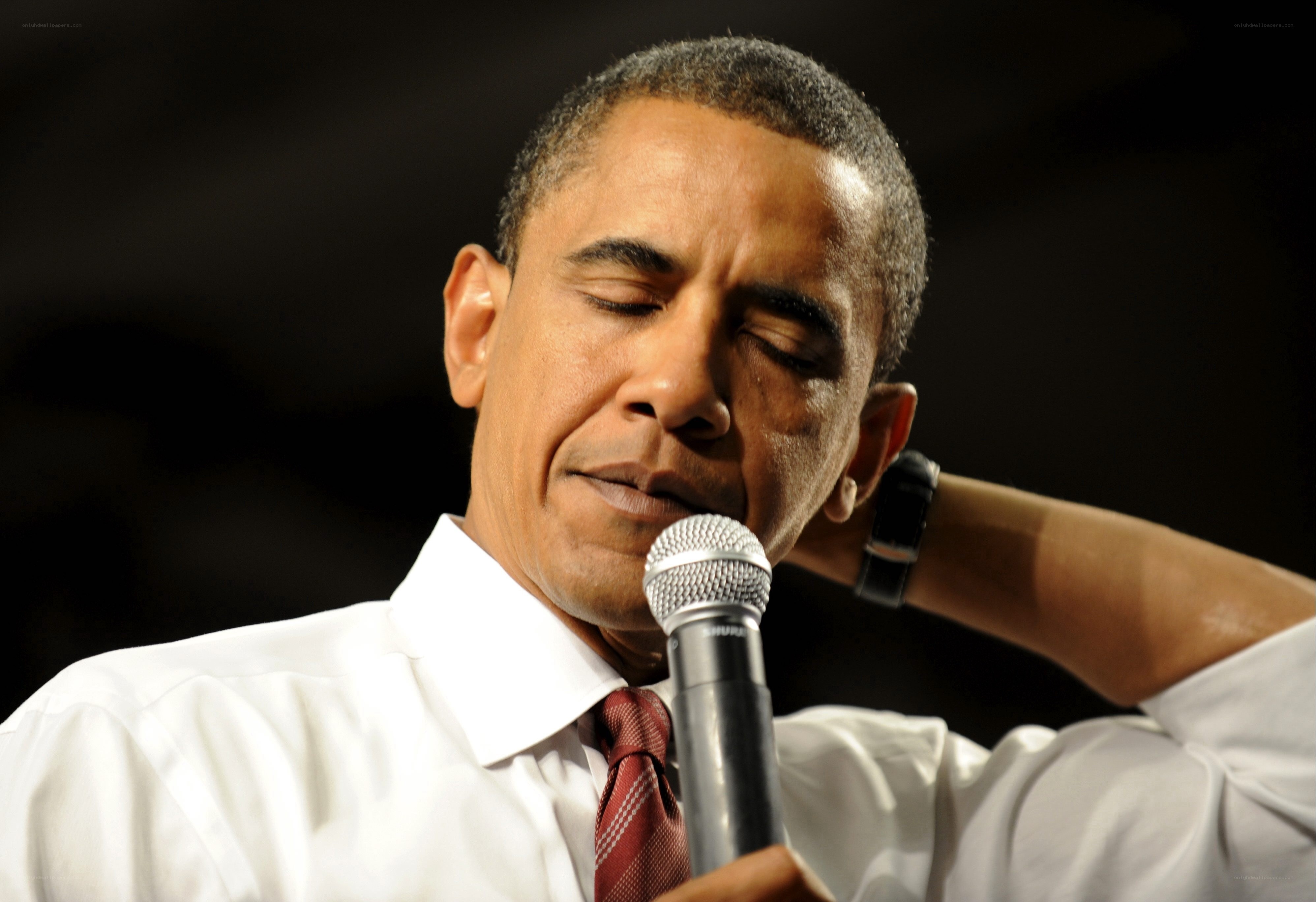 Obama speaking into microphone
