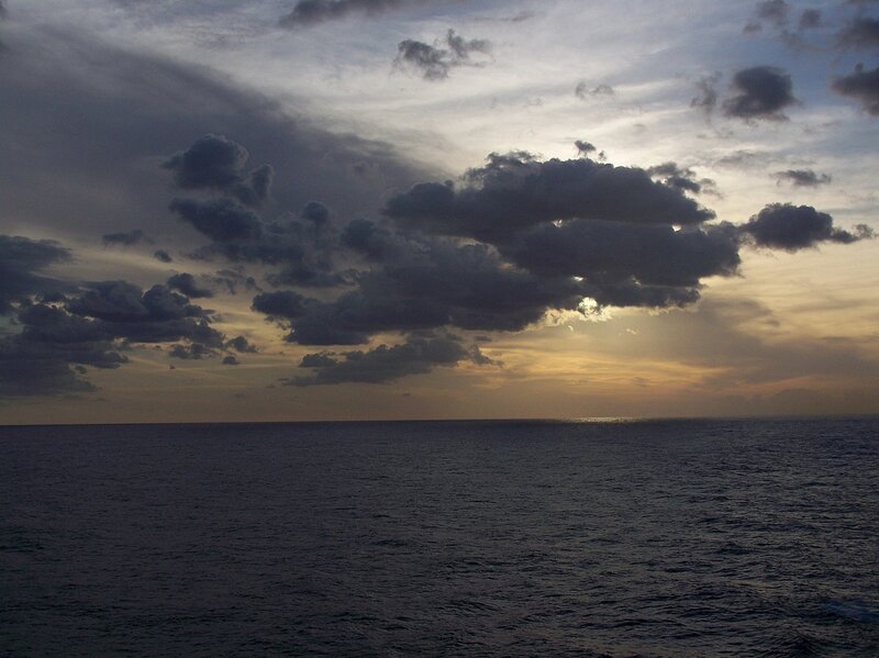 Ocean at dusk with cloudy sky