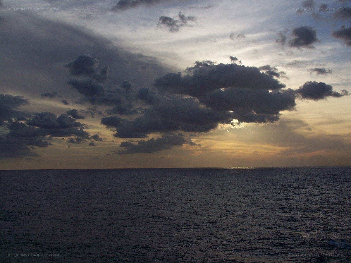 Ocean at dusk with cloudy sky