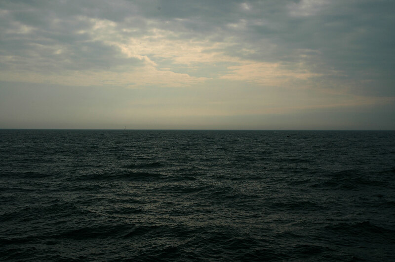 Ocean at dusk with cloudy sky
