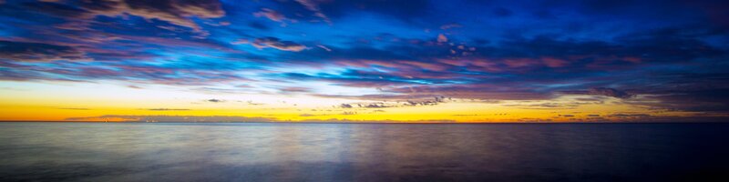 Ocean at Sunset — Blue, Serene, Photograph, Sky, Clouds, Horizon, Yellow, Purple