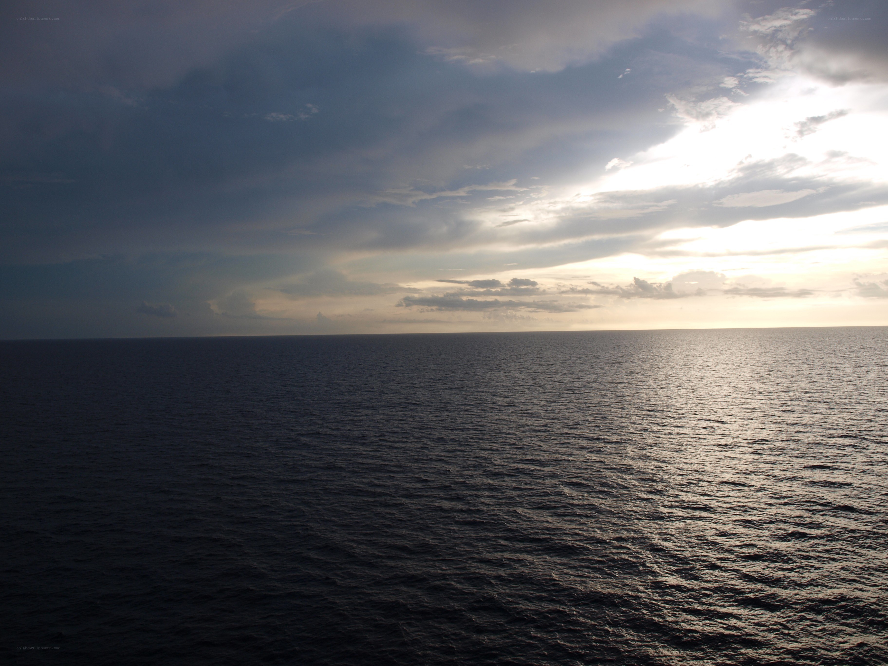ocean at sunset with clouds