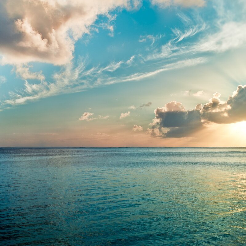 Ocean at sunset with clouds